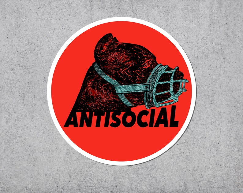 May include: A round sticker with a red background and a white border. The sticker features a detailed illustration of a dog's head wearing a blue muzzle. The word "ANTISOCIAL" is printed in black below the dog.
