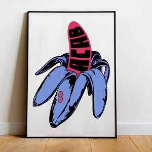 May include: Pop art style print featuring a peeled banana with a pink fruit and blue peel. The word "ACAB" is printed in black on the pink fruit. The print is framed in a black frame and set against a white background.