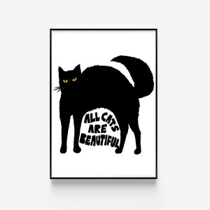 May include: A framed art print featuring a black cat silhouette with yellow eyes and the text "ALL CATS ARE BEAUTIFUL" in white. The cat is arched, with its tail up. The artwork is set against a white background.