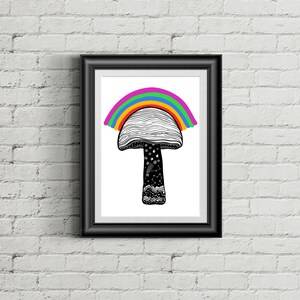 May include: Black framed art print featuring a whimsical mushroom design with a rainbow arching over the cap. The mushroom stem is black with white stars and constellations. The artwork is displayed against a white brick wall.