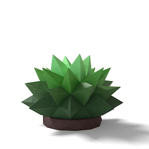 May include: A geometric papercraft succulent plant in shades of green, with sharp, triangular leaves. The plant sits in a brown, geometric pot. The design is modern and minimalist, set against a white background.