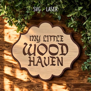 May include: A scalloped wooden sign featuring the text "MY LITTLE WOOD HAVEN" in dark brown lettering. The sign has a light wood grain center and a dark brown border, with the text "SVG - LASER" positioned above the sign in white font.