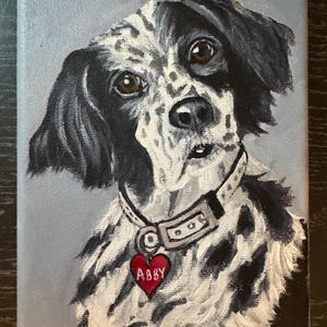 May include: A painted portrait of a dog with black and white fur, brown eyes, and a red heart-shaped tag that says "Abby." The dog is wearing a collar. The background is a light gray.