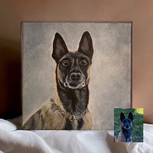 May include: A square canvas painting of a dog with a gold chain collar. The dog has a black muzzle and ears, with tan and brown fur. The background is a light gray color. A smaller image of the dog is in the bottom right corner.