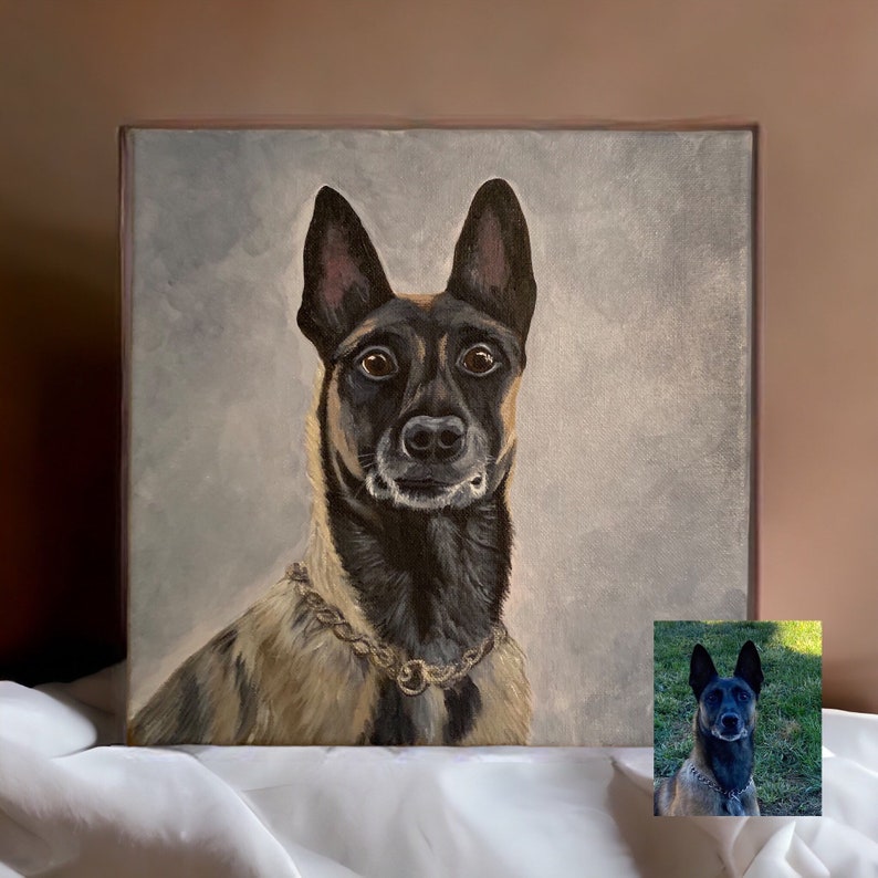 May include: A square canvas painting of a dog with a gold chain collar. The dog has a black muzzle and ears, with tan and brown fur. The background is a light gray color. A smaller image of the dog is in the bottom right corner.