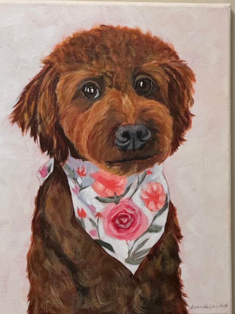 May include: A portrait of a brown dog with a floral bandana. The dog has dark eyes and a black nose. The bandana is white with pink and red roses and green leaves. The painting is on a canvas with a light pink background.
