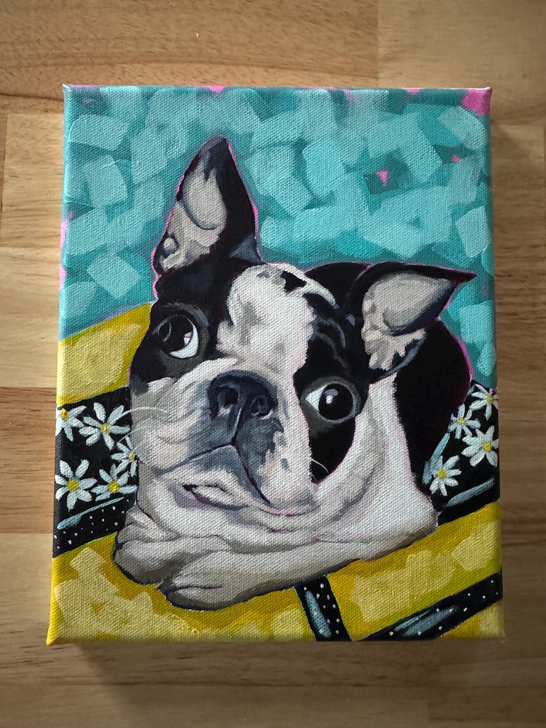 May include: A colorful painting of a Boston Terrier dog with a black and white coat. The dog is wearing a yellow collar with a black and white floral pattern. The background is a teal color with pink accents.