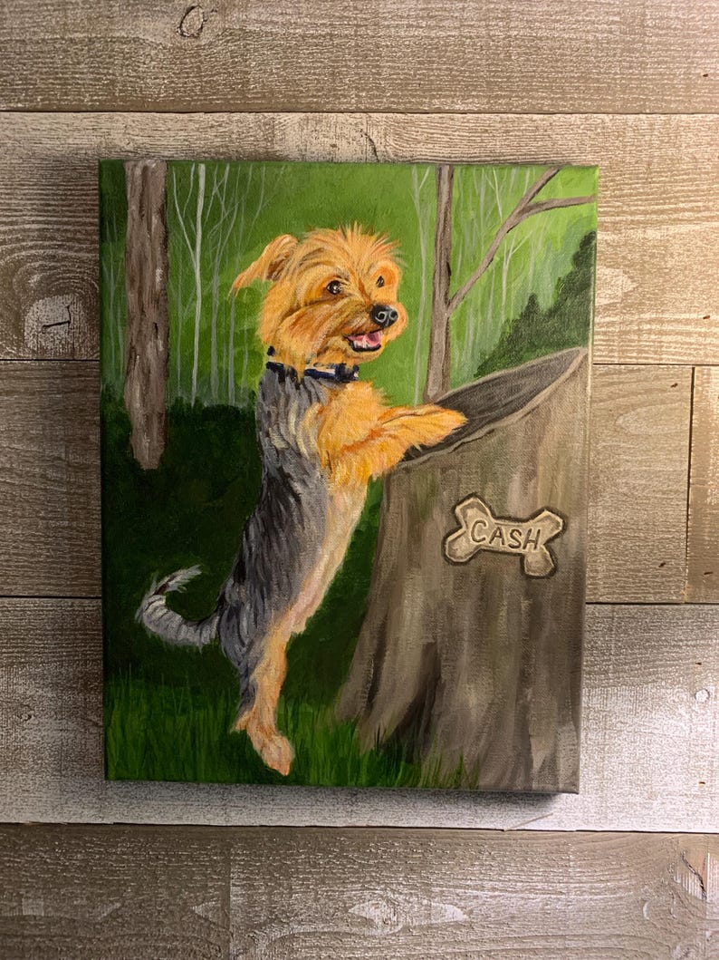 May include: A painted canvas depicts a Yorkshire Terrier dog with tan and gray fur, standing on its hind legs next to a tree stump. The dog is wearing a black collar. The tree stump has a bone-shaped sign that reads "CASH". The background shows a green forest.
