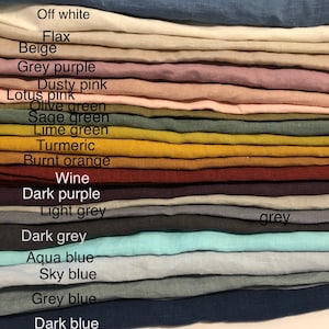 May include: A stack of fabric swatches in various colors, including post blue, off white, flax, beige, grey purple, dusty pink, lotus pink, olive green, sage green, lime green, turmeric, burnt orange, wine, dark purple, light grey, dark grey, aqua blue, sky blue, grey blue, and dark blue.
