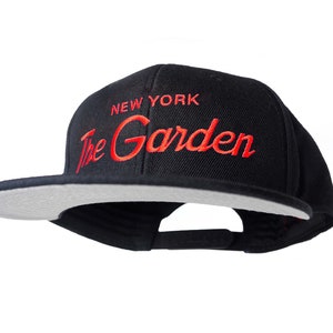 New York 90s Basketball Hat | The Garden Vintage Snapback Cap in Black with Orange Embroidered Script Lettering