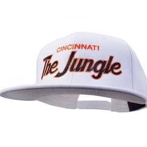 Cincinnati 90s Hat | The Jungle Embroidered White Football Snapback Cap with Script Lettering