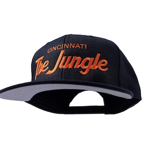 Cincinnati 90s Hat | The Jungle Embroidered Black Football Snapback Cap with Script Lettering