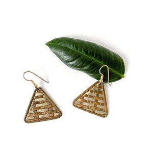 May include: A pair of gold triangle earrings with a woven pattern. The earrings are made of brass and have a silver finish.