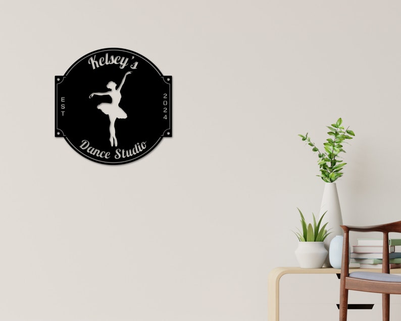 May include: Black and white sign with the text "Kelsey's Dance Studio" and a silhouette of a ballerina. The sign also includes the text "EST 2024".