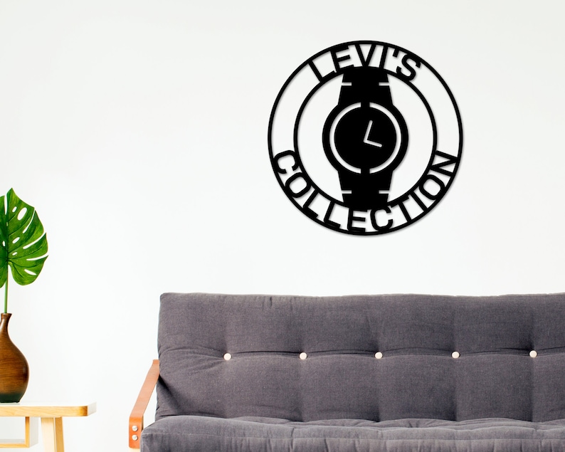 May include: Black metal wall art featuring a watch with the text "Levi's Collection" around it.