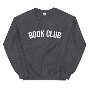 May include: A dark grey sweatshirt with the text "BOOK CLUB" printed in white on the front.