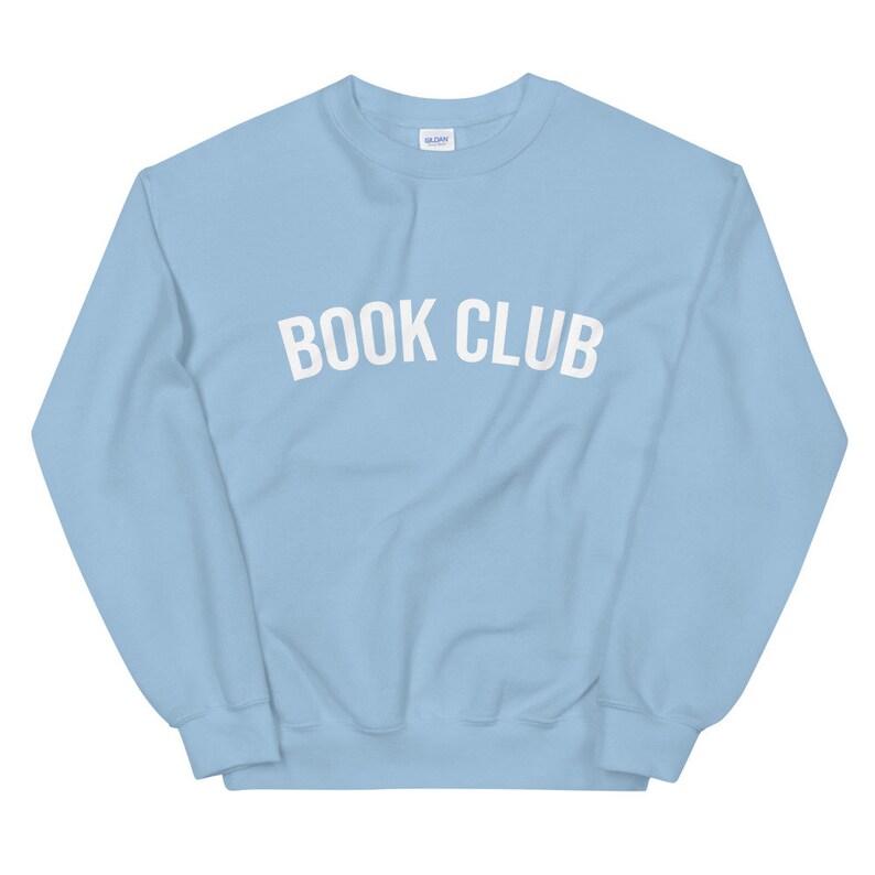 May include: A light blue sweatshirt with the text "BOOK CLUB" in white.