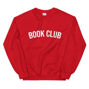 May include: Red sweatshirt with the text "BOOK CLUB" in white letters.