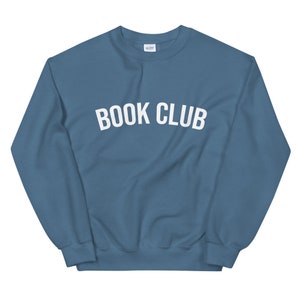 May include: A blue sweatshirt with the text "BOOK CLUB" in white letters.