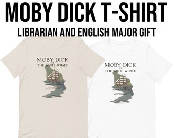 May include: A white and a beige t-shirt with a graphic of the book cover for Moby Dick, or The White Whale by Herman Melville. The text on the t-shirt reads "Moby Dick or The White Whale by Herman Melville".