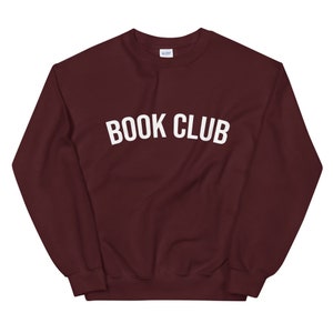 May include: Burgundy sweatshirt with white text that reads "BOOK CLUB".