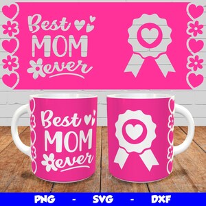 May include: Two white mugs with pink backgrounds and white text that reads "Best Mom Ever" with a flower and heart design. One mug has a white ribbon and heart design.