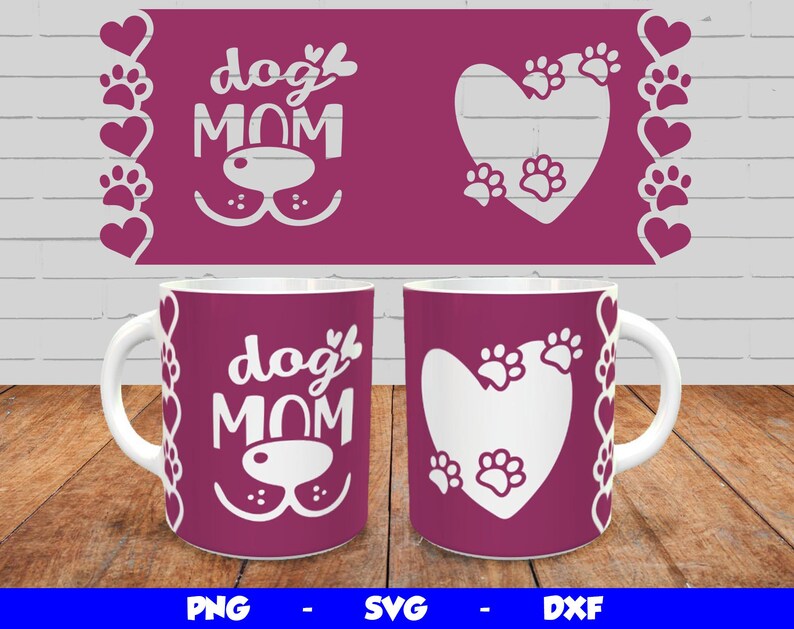 May include: Two white ceramic mugs with pink handles. One mug features the text "dog mom" with a paw print design. The other mug features a heart with paw prints inside. Both mugs have a pink background with a border of hearts and paw prints.