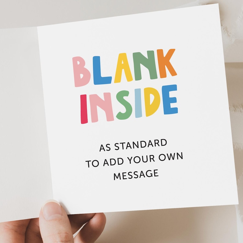 May include: A blank greeting card with the words "BLANK INSIDE" in colorful letters. The text "AS STANDARD TO ADD YOUR OWN MESSAGE" is printed below the colorful letters.
