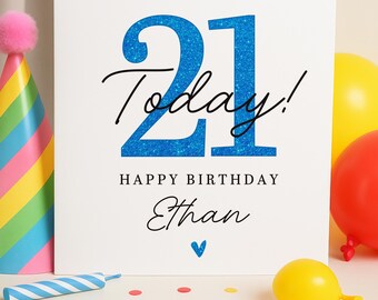 May include: A white birthday card with the number "21" in blue glitter, the word "Today!" in black script, and the name "Ethan" below "Happy Birthday." Party decorations include balloons, confetti, and a party hat.