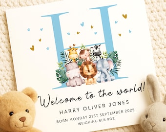 May include: A baby announcement card with a large blue "H" and the text "Welcome to the world!". The card features illustrations of safari animals and gold hearts. The baby's name, birthdate, and weight (6lb 8oz) are also printed.