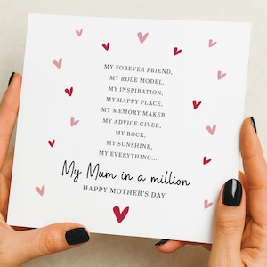 以下が含まれることがあります： ピンクと赤のハートのイラストが描かれた白い母の日カード。「My Mum in a million」と「Happy Mother's Day」の文字が書かれています。カードには「My forever friend」や「My sunshine」などのフレーズも含まれています。