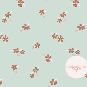 Op de afbeelding: Een naadloos patroon met een herhalend ontwerp van kleine bruine bloemen met witte centra op een lichtblauwe achtergrond. Het patroon is subtiel en delicaat, met een minimalistische esthetiek. De tekst "mielenpetra designs" staat in een witte cirkel in de rechterbenedenhoek van de afbeelding.