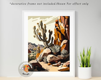 Peut inclure: Kit de peinture par numéros représentant un paysage désertique avec un grand cactus, des rochers et un chemin de terre. Le kit comprend une variété de couleurs et un pinceau.