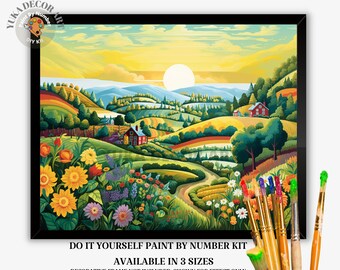 May include: A framed paint-by-number kit featuring a vibrant landscape scene with rolling hills, a winding road, and a setting sun. The artwork includes colorful flowers and houses. The kit is available in three sizes.