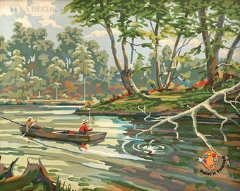 May include: A paint by numbers kit depicting a serene lake scene with two people in a boat fishing. The lake is surrounded by lush green trees and a fallen tree trunk. The water is a light blue-green color with ripples and a small splash where a fish has jumped. The sky is a light blue with white clouds. The kit includes a paintbrush and a palette of colors.