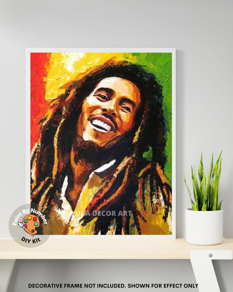 May include: Paint by numbers kit featuring a colorful portrait of Bob Marley with a yellow, red, and green background. The kit includes paintbrushes and acrylic paints.