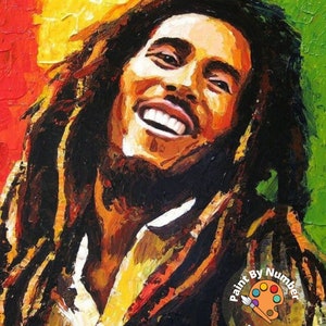 May include: A paint by numbers kit featuring a colorful portrait of Bob Marley. The image shows a close-up of his face with a bright smile and dreadlocks. The kit includes a paint palette, brushes, and a canvas with numbered sections.