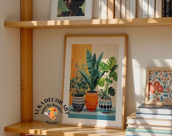 May include: A framed print of a painting of three potted plants with colorful patterned pots. The print is on a shelf with other books and framed artwork. The text "Yuka Decor Art Paint By Number DIY Kit" is on a sticker in the lower left corner of the image.