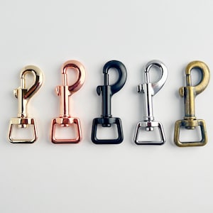 May include: Five metal clasps in different finishes: gold, rose gold, black, silver, and brass.