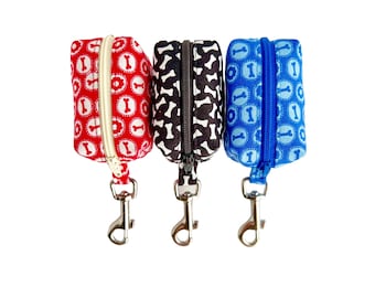 A dog lover gift of Dog bone themed Dog Poop Bag Holders in a variety of colors with an easy leash attachment
