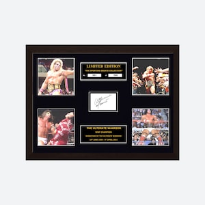 May include: A framed limited edition collectible featuring four photographs of The Ultimate Warrior in wrestling attire, a central autograph, and text plaques reading "LIMITED EDITION" and "THE ULTIMATE WARRIOR WWF CHAMPION" with dates.