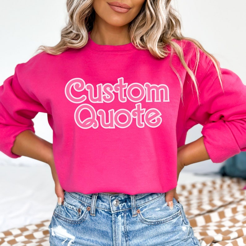 May include: A pink sweatshirt with the text "Custom Quote" in white outlined letters.