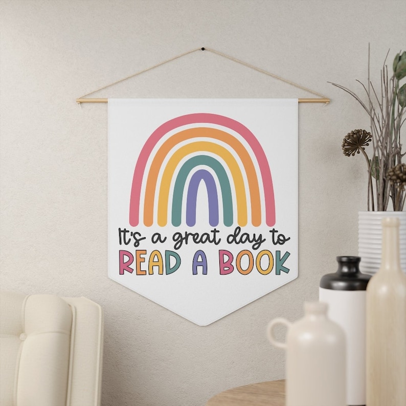 May include: A white banner with a rainbow and the text "It's a great day to read a book".