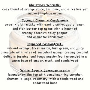 May include: A close-up of a candle jar with a white label and black text describing four different candle scents: Christmas Warmth, Coconut Cream + Cardamom, Peppered Passionfruit, and White Sage + Lavender scent.