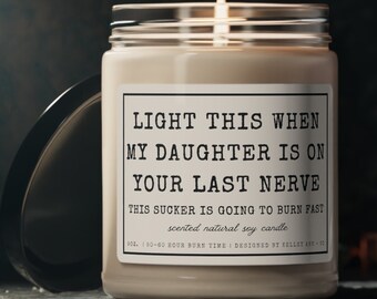 May include: A white soy candle in a glass jar with a black label that reads "LIGHT THIS WHEN MY DAUGHTER IS ON YOUR LAST NERVE THIS SUCKER IS GOING TO BURN FAST scented natural soy candle 9OZ. 50-60 HOUR BURN TIME I DESIGNED BY KELLEY ANN CO."