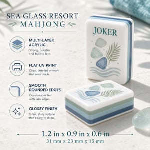 May include: Two white acrylic mahjong tiles with blue and green layered sides, featuring a printed design of sea glass and a palm frond. One tile stands upright labeled JOKER, while the other lies flat. Dimensions are 1.2 in x 0.9 in x 0.6 in.