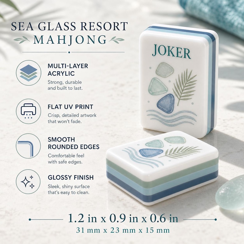 May include: Two white acrylic mahjong tiles with blue and green layered sides, featuring a printed design of sea glass and a palm frond. One tile stands upright labeled JOKER, while the other lies flat. Dimensions are 1.2 in x 0.9 in x 0.6 in.