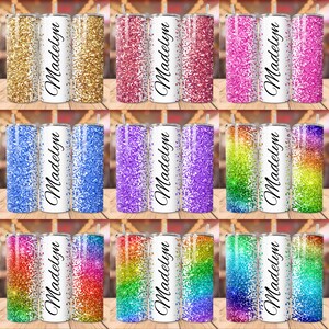 May include: Set of nine 20 ounce stainless steel tumblers with a white background and a glitter design. Each tumbler features the name "Madelyn" in black cursive lettering. The glitter designs include gold, pink, blue, purple, rainbow, and green.