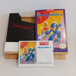 May include: A complete set of the classic NES game Mega Man 4, including the game cartridge, instruction manual, and box. The box is purple and blue with a picture of Mega Man on the front. The game cartridge is black with a red Nintendo logo. The instruction manual is white with a picture of Mega Man on the front.