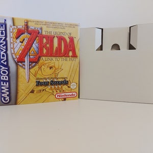 Puede incluir: Una caja de cartucho de juego Game Boy Advance amarilla con una imagen de Link de The Legend of Zelda: A Link to the Past. El juego se llama "Four Swords" y es un juego de Nintendo.